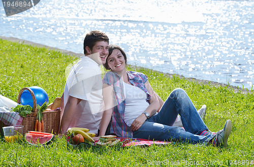 Image of happy young couple having a picnic outdoor