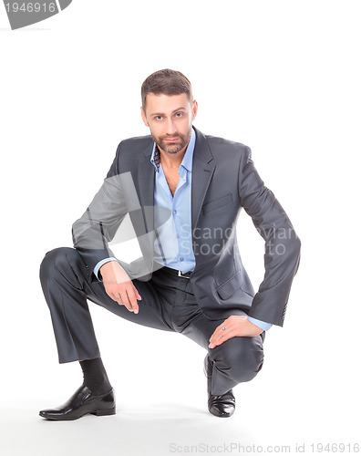 Image of Portrait businessman sitting on his haunches