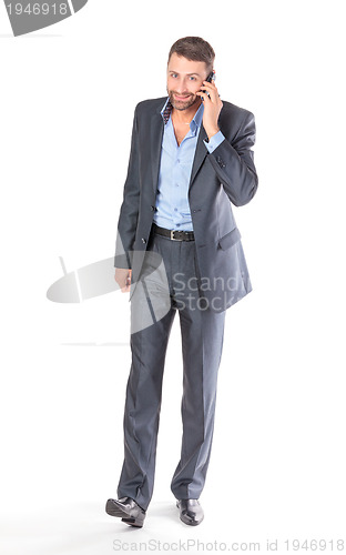 Image of Full length portrait businessman with mobile phone