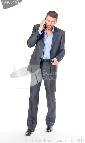 Image of Full length portrait businessman with mobile phone