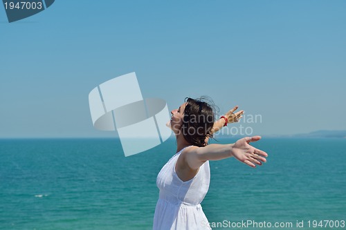 Image of happy young woman with spreading arms to sky