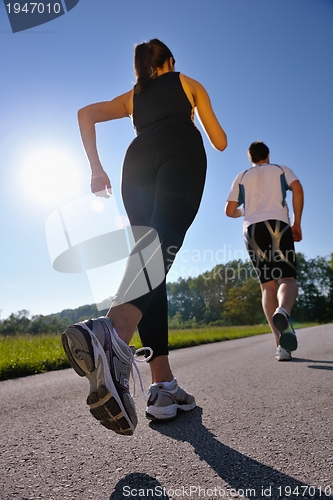 Image of Young couple jogging