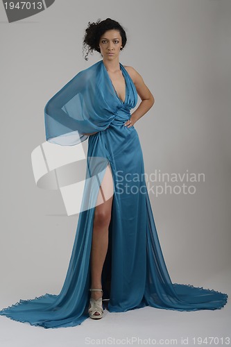Image of elegant woman in fashionable dress posing in the studio