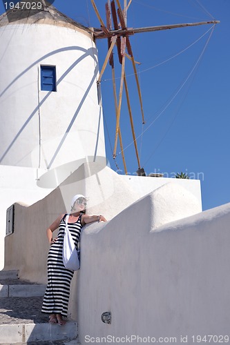 Image of Greek woman on the streets of Oia, Santorini, Greece