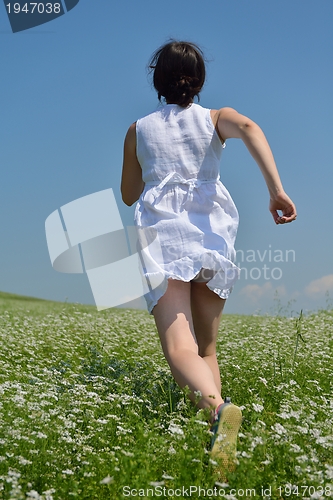 Image of Young happy woman in green field