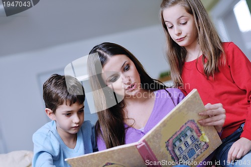 Image of young mom play with their kids at home and reading book