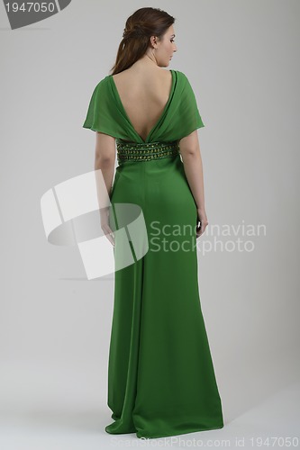 Image of elegant woman in fashionable dress posing in the studio