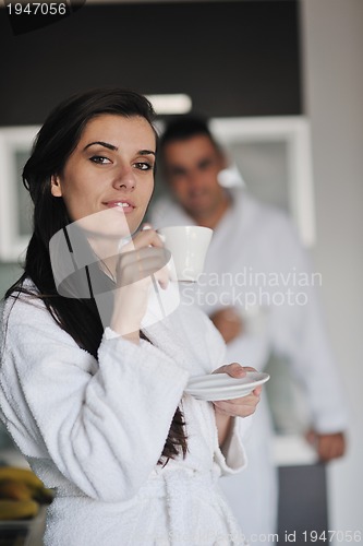 Image of Young love couple taking fresh morning cup of coffee