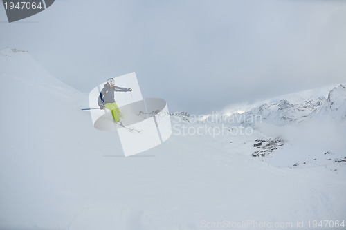 Image of skiing on fresh snow at winter season at beautiful sunny day