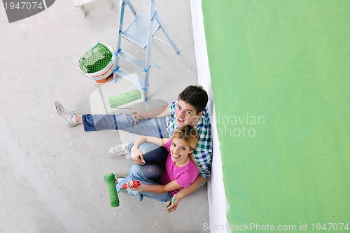 Image of happy young cople relaxing after painting in new home