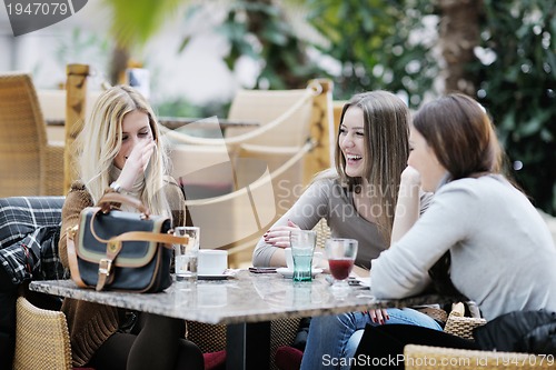 Image of cute smiling women drinking a coffee