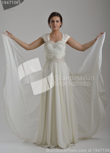 Image of elegant woman in fashionable dress posing in the studio