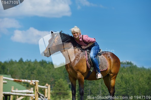 Image of happy woman  ride  horse