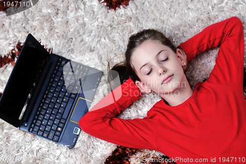 Image of happy school girl relaxing at home