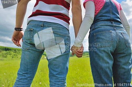Image of Portrait of romantic young couple smiling together outdoor