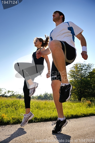 Image of Young couple jogging