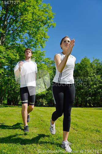 Image of Young couple jogging