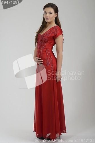 Image of elegant woman in fashionable dress posing in the studio