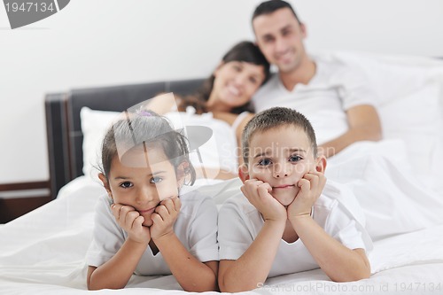 Image of happy young Family in their bedroom
