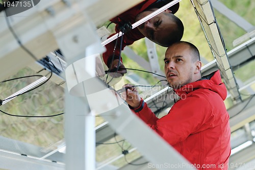 Image of Male solar panel engineer at work place