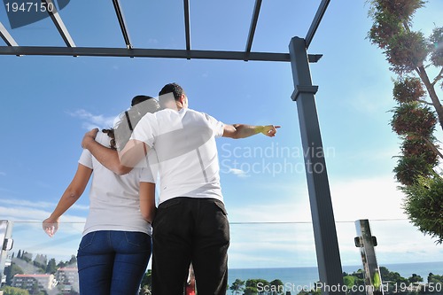 Image of couple relaxing on balcony
