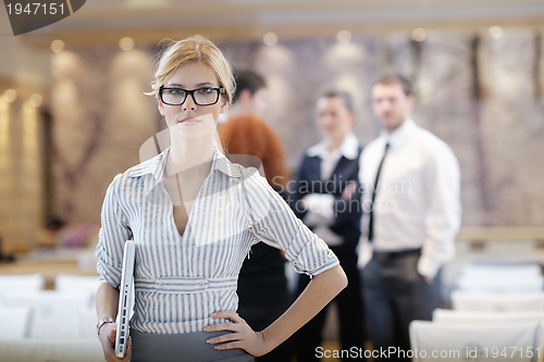 Image of business woman standing with her staff at conference