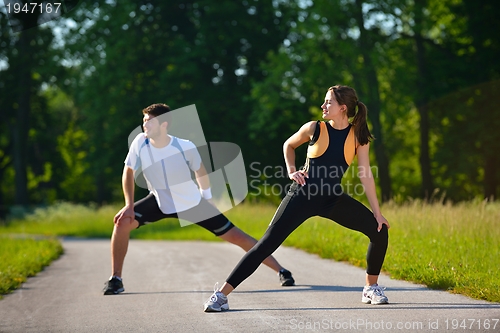 Image of Couple doing stretching exercise  after jogging
