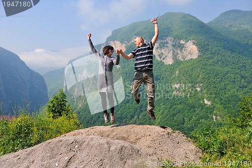 Image of happy young couple jumping in the air