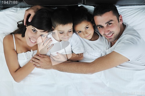 Image of happy young Family in their bedroom