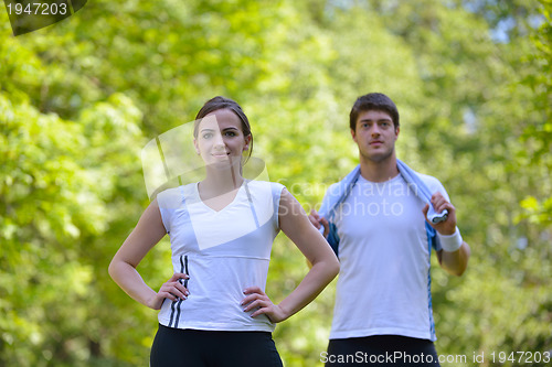 Image of Couple doing stretching exercise  after jogging
