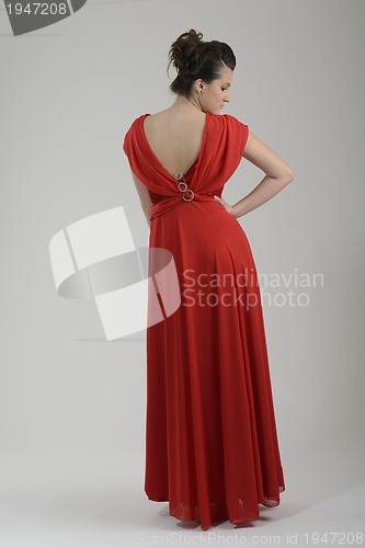 Image of elegant woman in fashionable dress posing in the studio