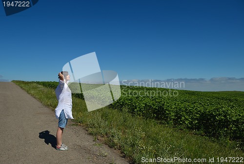 Image of Young happy woman in green field