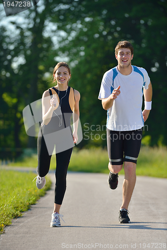 Image of Young couple jogging at morning