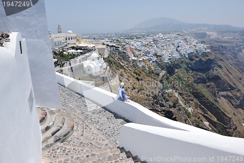 Image of Greek woman on the streets of Oia, Santorini, Greece