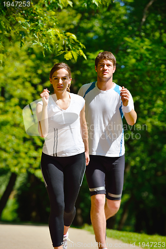 Image of Young couple jogging