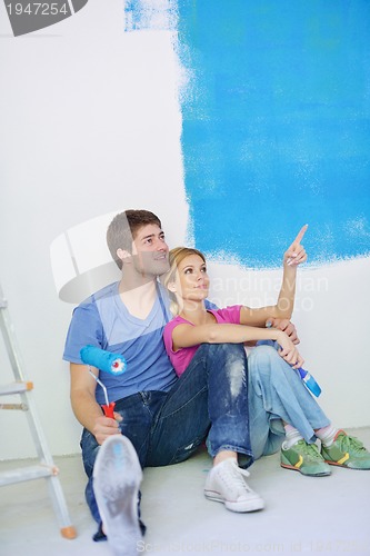 Image of happy young cople relaxing after painting in new home