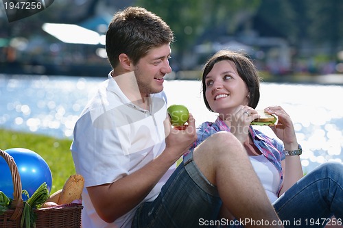 Image of happy young couple having a picnic outdoor