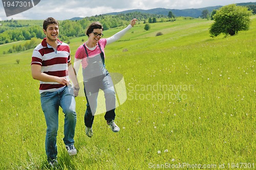 Image of Portrait of romantic young couple smiling together outdoor