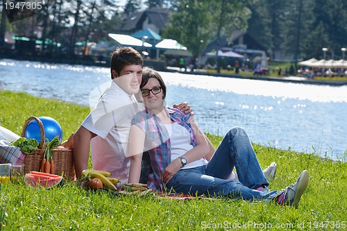 Image of happy young couple having a picnic outdoor