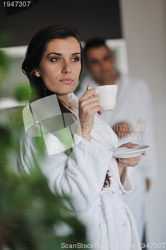 Image of Young love couple taking fresh morning cup of coffee