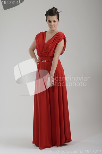 Image of elegant woman in fashionable dress posing in the studio