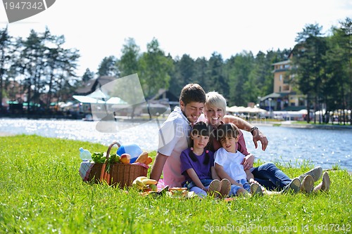 Image of Happy family playing together in a picnic outdoors