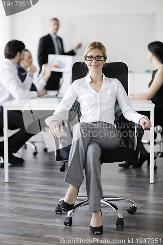 Image of business woman with her staff in background