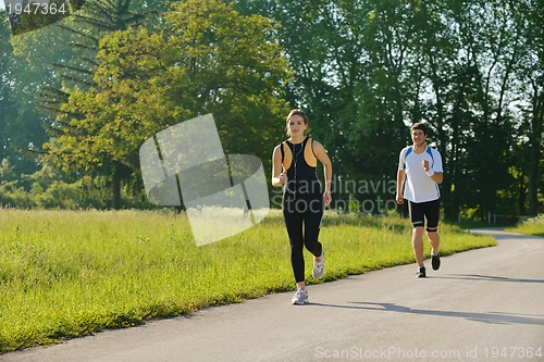 Image of Young couple jogging at morning