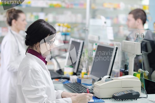 Image of pharmacist suggesting medical drug to buyer in pharmacy drugstor