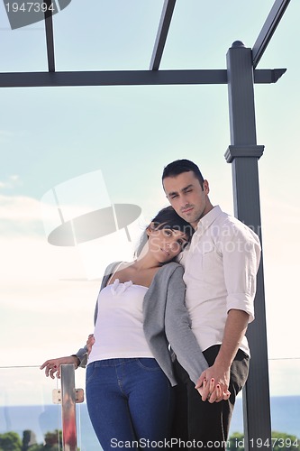 Image of couple relaxing on balcony