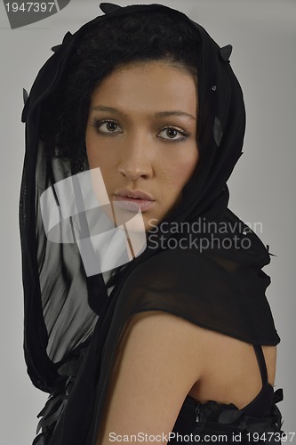 Image of elegant woman in fashionable dress posing in the studio