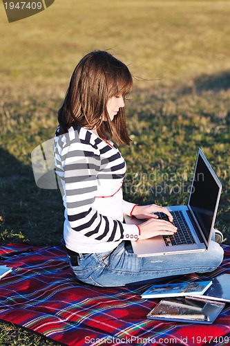 Image of young teen girl work on laptop outdoor