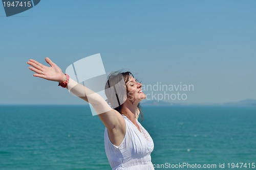 Image of happy young woman with spreading arms to sky
