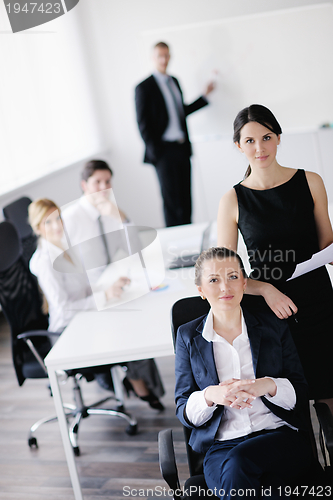 Image of business woman with her staff in background